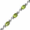 Thumbnail Image 0 of Oval Peridot and Diamond Accent Bracelet in Sterling Silver - 7.25"
