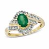 Thumbnail Image 0 of Oval Emerald and 1/3 CT. T.W. Baguette and Round Diamond Ring in 14K Gold