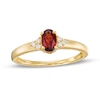 Thumbnail Image 1 of Oval Garnet and 1/20 CT. T.W. Diamond Tri-Sides Ring in 10K Gold - Size 7