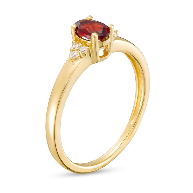 Oval Garnet and 1/20 CT. T.W. Diamond Tri-Sides Ring in 10K Gold - Size 7