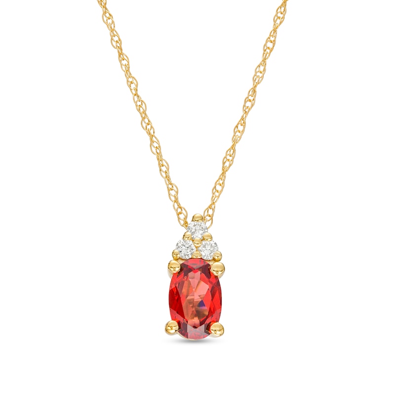 Oval Garnet and 1/20 CT. T.W. Diamond Pendant in 10K Gold | Zales Outlet