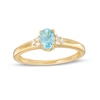 Thumbnail Image 1 of Oval Swiss Blue Topaz and 1/20 CT. T.W. Diamond Tri-Sides Ring in 10K Gold - Size 7