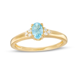 Oval Swiss Blue Topaz and 1/20 CT. T.W. Diamond Tri-Sides Ring in 10K Gold - Size 7