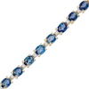 Thumbnail Image 1 of Oval Blue Sapphire and 1/6 CT. T.W. Diamond Alternating Line Bracelet in 10K Gold