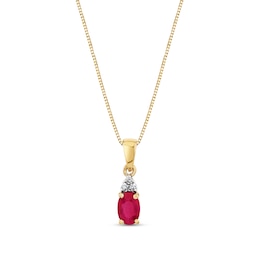 Oval Ruby and 1/20 CT. T.W. Diamond Tri-Top Pendant in 14K Gold