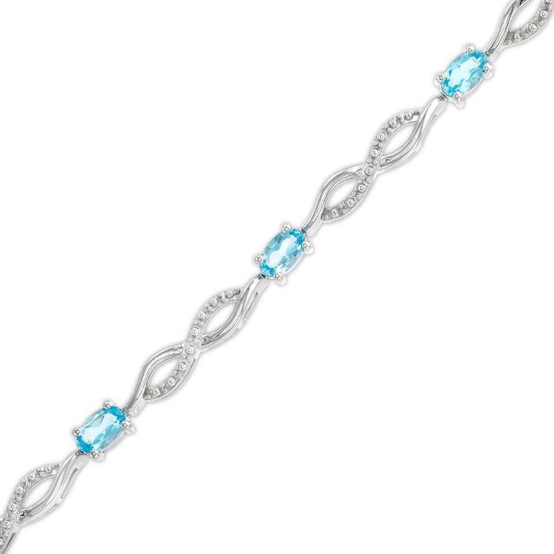 Oval Swiss Blue Topaz and Diamond Accent Infinity Braid Line Bracelet in Sterling Silver - 7.25"