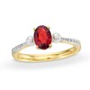 Thumbnail Image 0 of Oval Garnet, Cultured Freshwater Pearl and Diamond Accent Three Stone Ring in 10K Gold