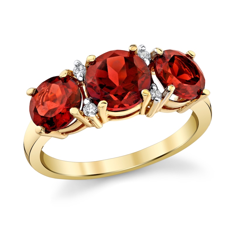 Garnet and 1/20 CT. T.W. Diamond Three Stone Ring in 14K Gold