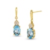 Thumbnail Image 0 of Oval Swiss Blue Topaz and 1/20 CT. T.W. Diamond Drop Earrings in 10K Gold