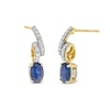 Thumbnail Image 0 of Oval Blue Sapphire and 1/5 CT. T.W. Diamond Twist Drop Earrings in 10K Gold