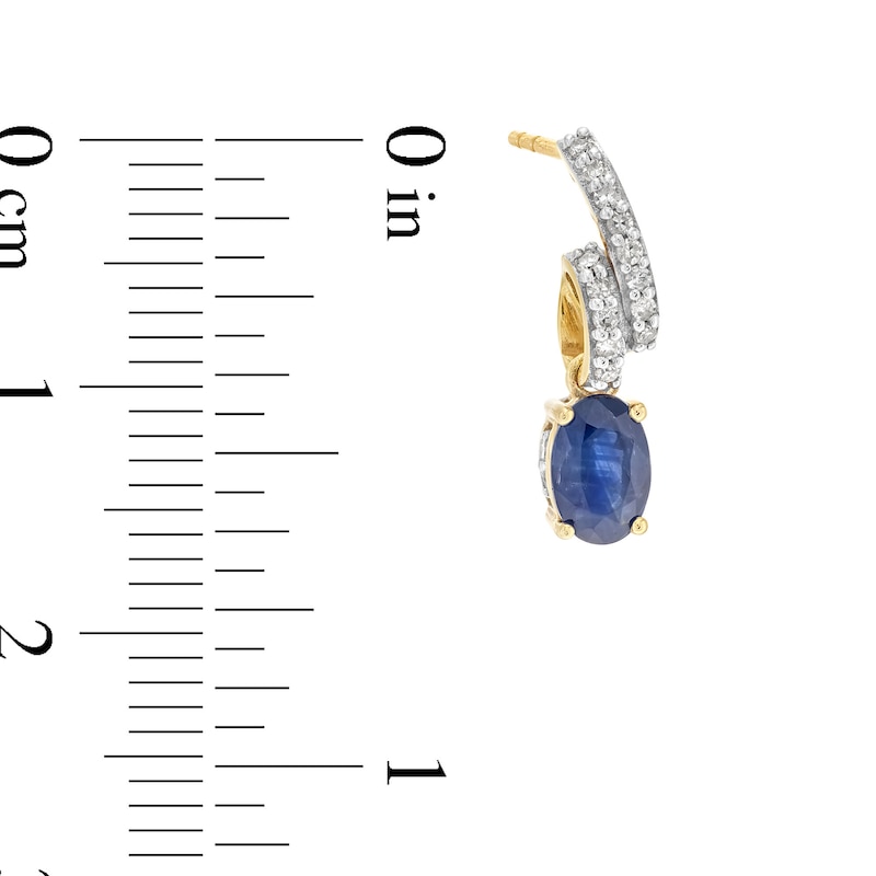 Oval Blue Sapphire and 1/5 CT. T.W. Diamond Twist Drop Earrings in 10K Gold