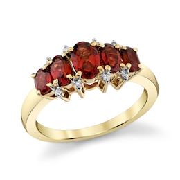 Oval Garnet and 1/20 CT. T.W. Diamond Graduated Five Stone Ring in 10K Gold