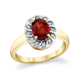 Oval Garnet and 1/8 CT. T.W. Diamond Swirl Frame Ring in 10K Gold