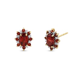 Oval Garnet and 1/15 CT. T.W. Diamond Alternating Frame Stud Earrings in 14K Gold