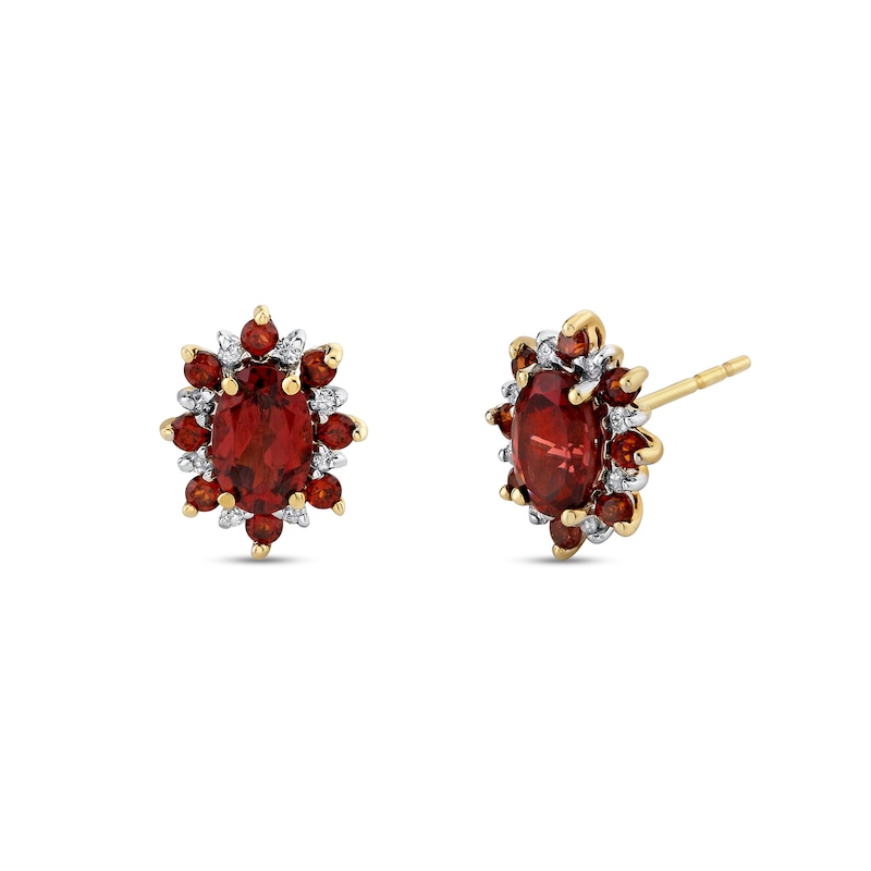 Main Image 1 of Oval Garnet and 1/15 CT. T.W. Diamond Alternating Frame Stud Earrings in 14K Gold