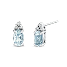 Oval Aquamarine and 1/20 CT. T.W. Diamond Tri-Top Stud Earrings in 14K White Gold